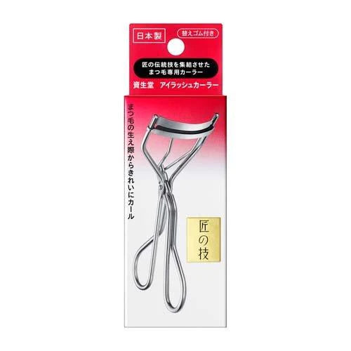 Eyelash curler in packaging with Japanese text on a white background